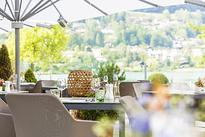 Sitzplatz auf der Terrasse unter dem Sonnenschirm im Restaurant Egener Bucht Althoff Seehotel Überfahrt 